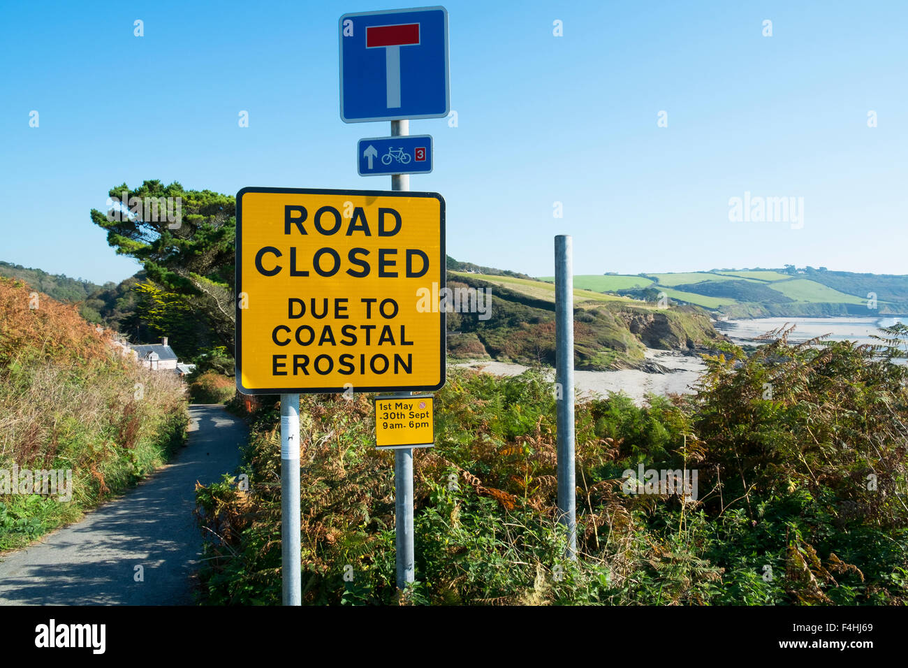 Strada chiusa a causa di erosione costiera vicino a spiaggia Pendower in Cornwall, Regno Unito Foto Stock