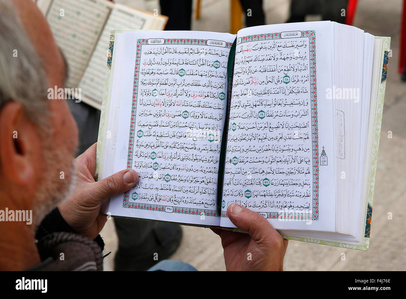 Palestinesi la lettura del Corano al di fuori della Moschea di Al-Aqsa, Gerusalemme, Israele, Medio Oriente Foto Stock