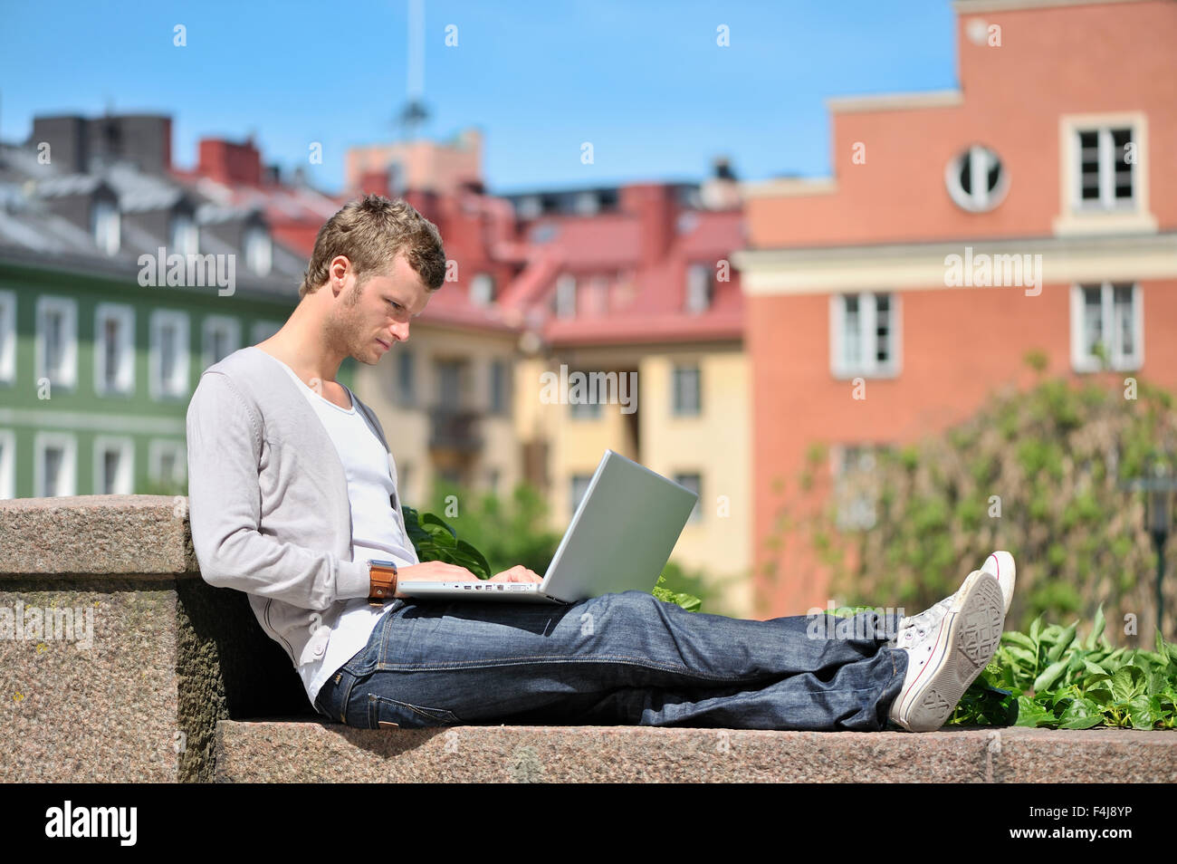 Un giovane uomo che utilizza un computer portatile, Svezia. Foto Stock