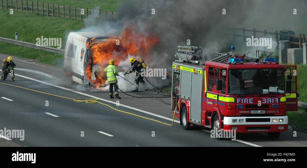 I vigili del fuoco di mettere fuori un furgone fire in autostrada Foto Stock