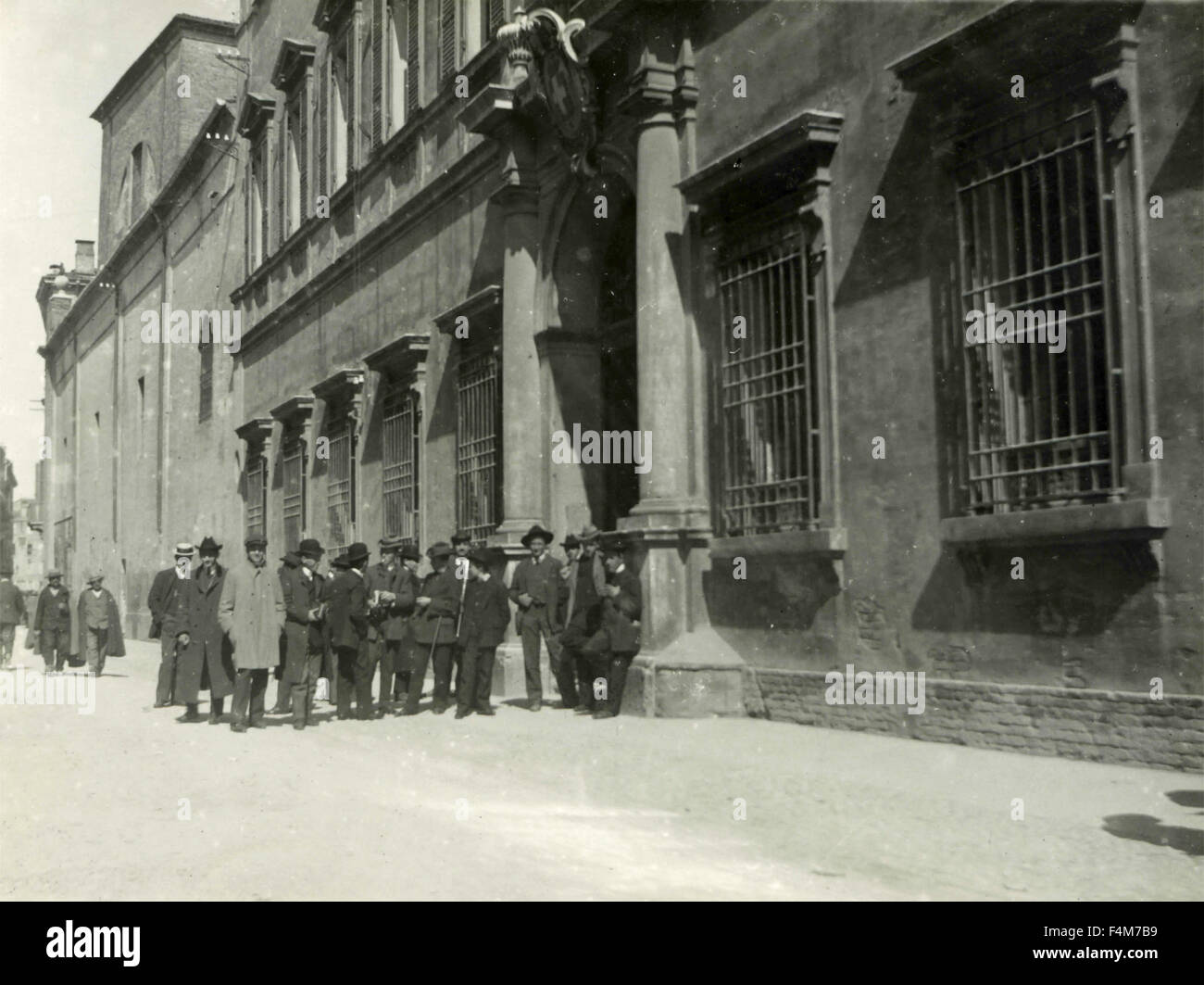 Persone in attesa di fronte ad un edificio, Italia Foto Stock