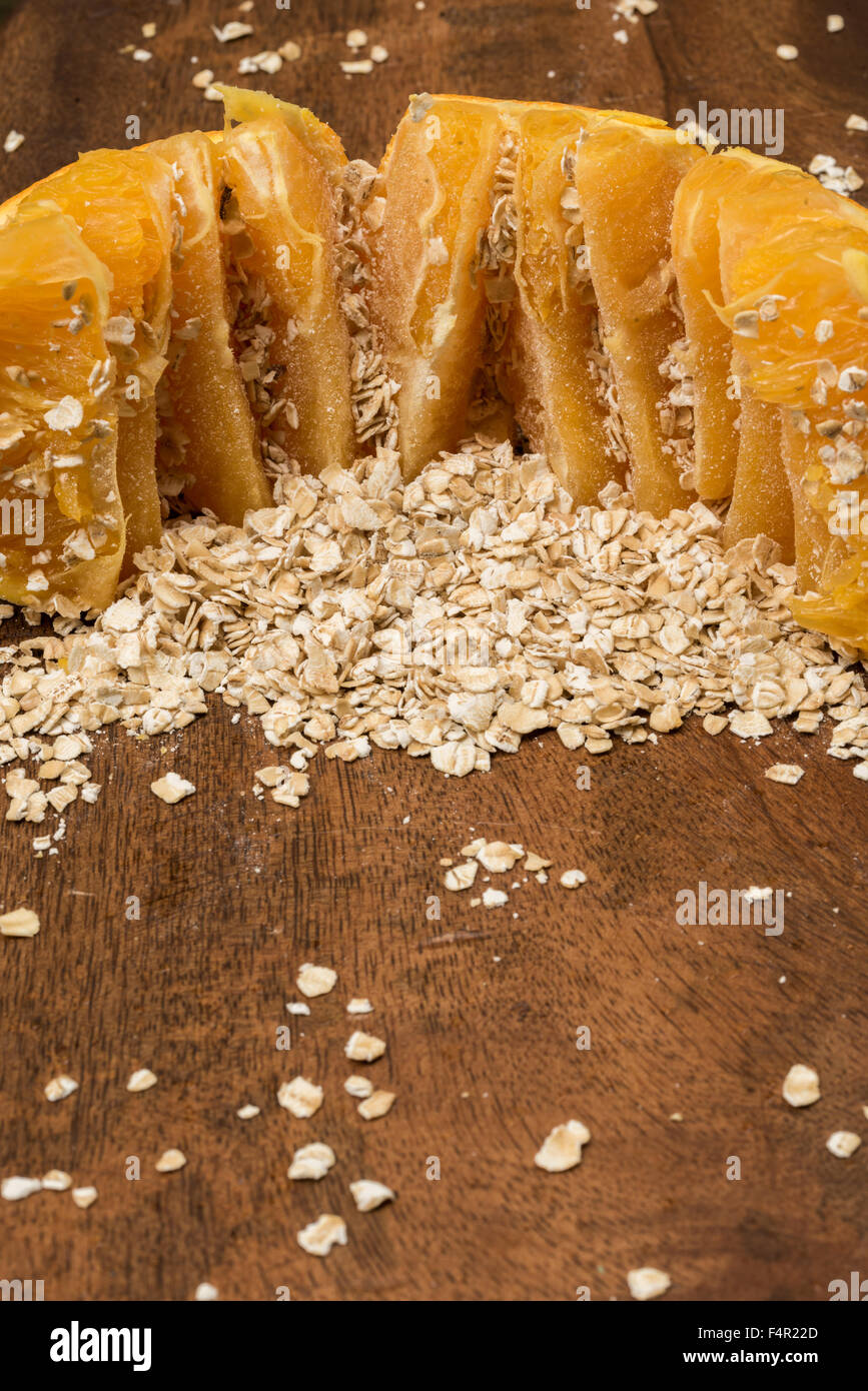 Aperto arancione e avena o farina di avena su una tavola di legno. Farina di avena + arancione = cibo sinergia Foto Stock