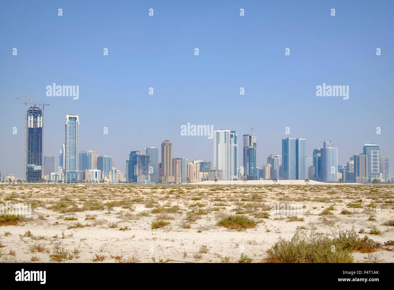 Il giorno dello skyline di alto e moderno appartamento edifici dal deserto in Sharjah Emirati Arabi Uniti Foto Stock