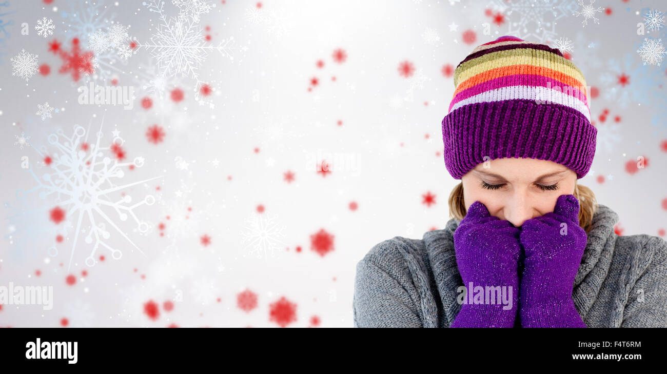 Immagine composita di congelare la donna con i guanti e un cappello Foto Stock