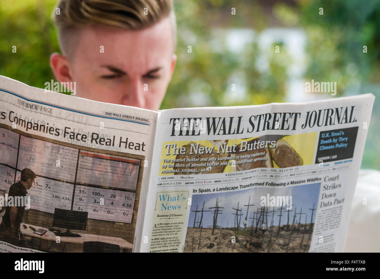 Un giovane uomo professionale la lettura del Wall Street Journal Foto Stock