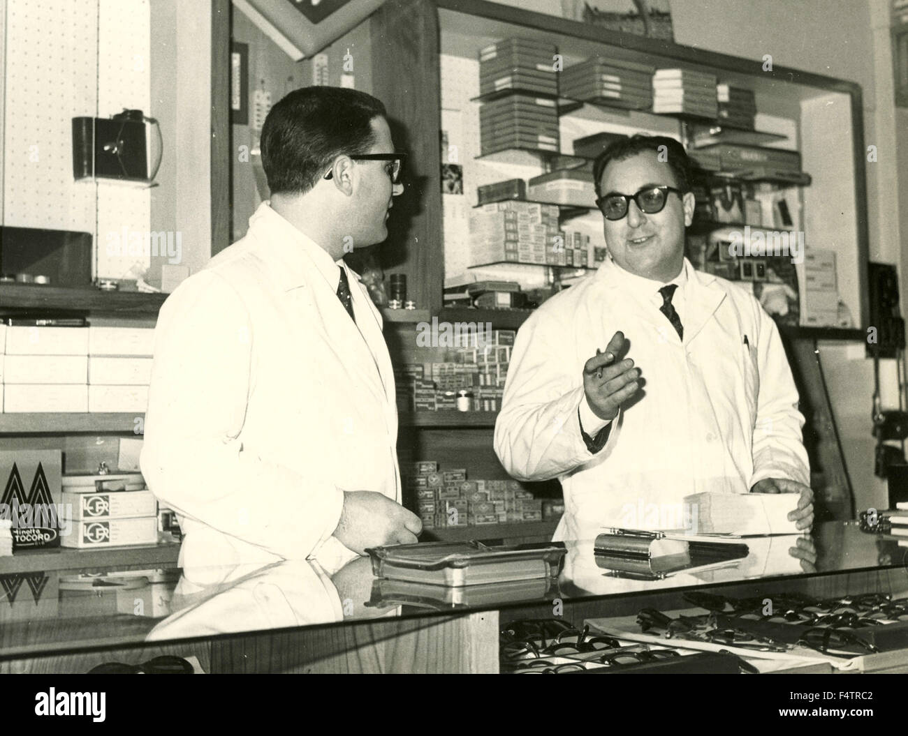 Due impiegati in camici nell'ottico del negozio, Italia Foto Stock