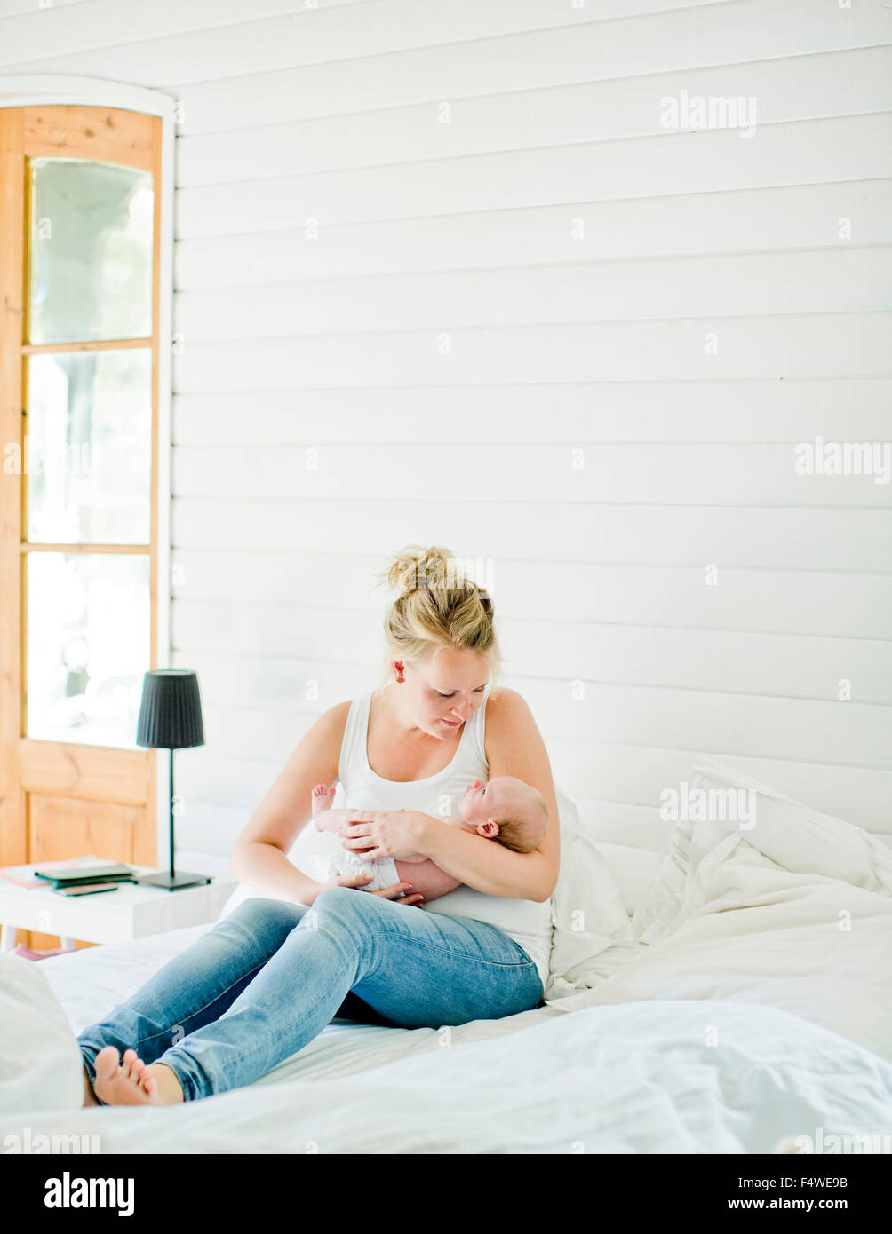 Metà donna adulta holding baby boy (0-1 mesi) nelle sue braccia Foto Stock