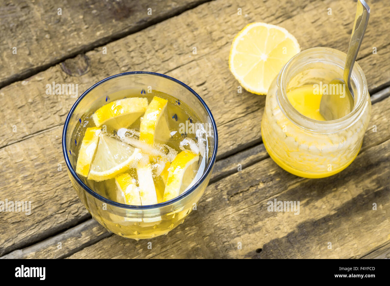 Bicchiere di sangria in bianco con limone e miele vaso su un tavolo in legno in stile rustico Foto Stock