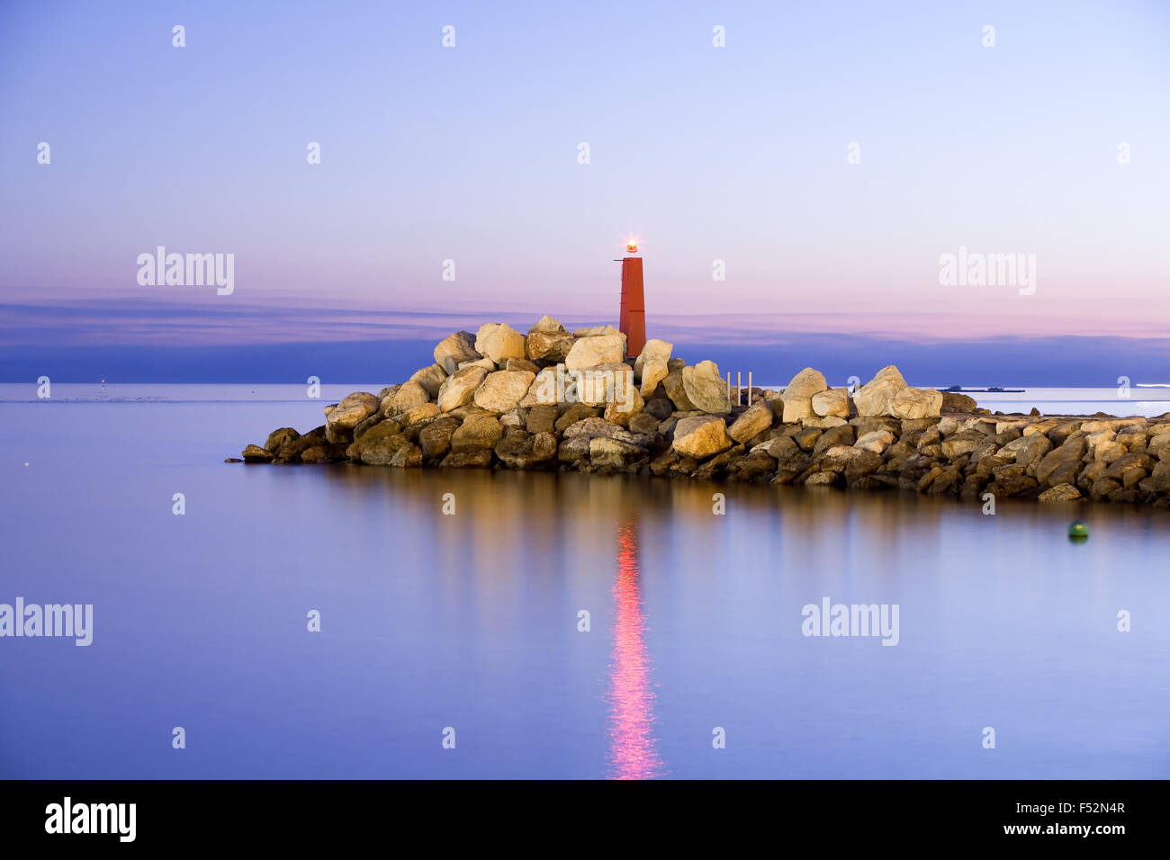 Faro nella notte molto lunga esposizione con un teleobiettivo medio lente sul treppiede fotocamera montata Foto Stock