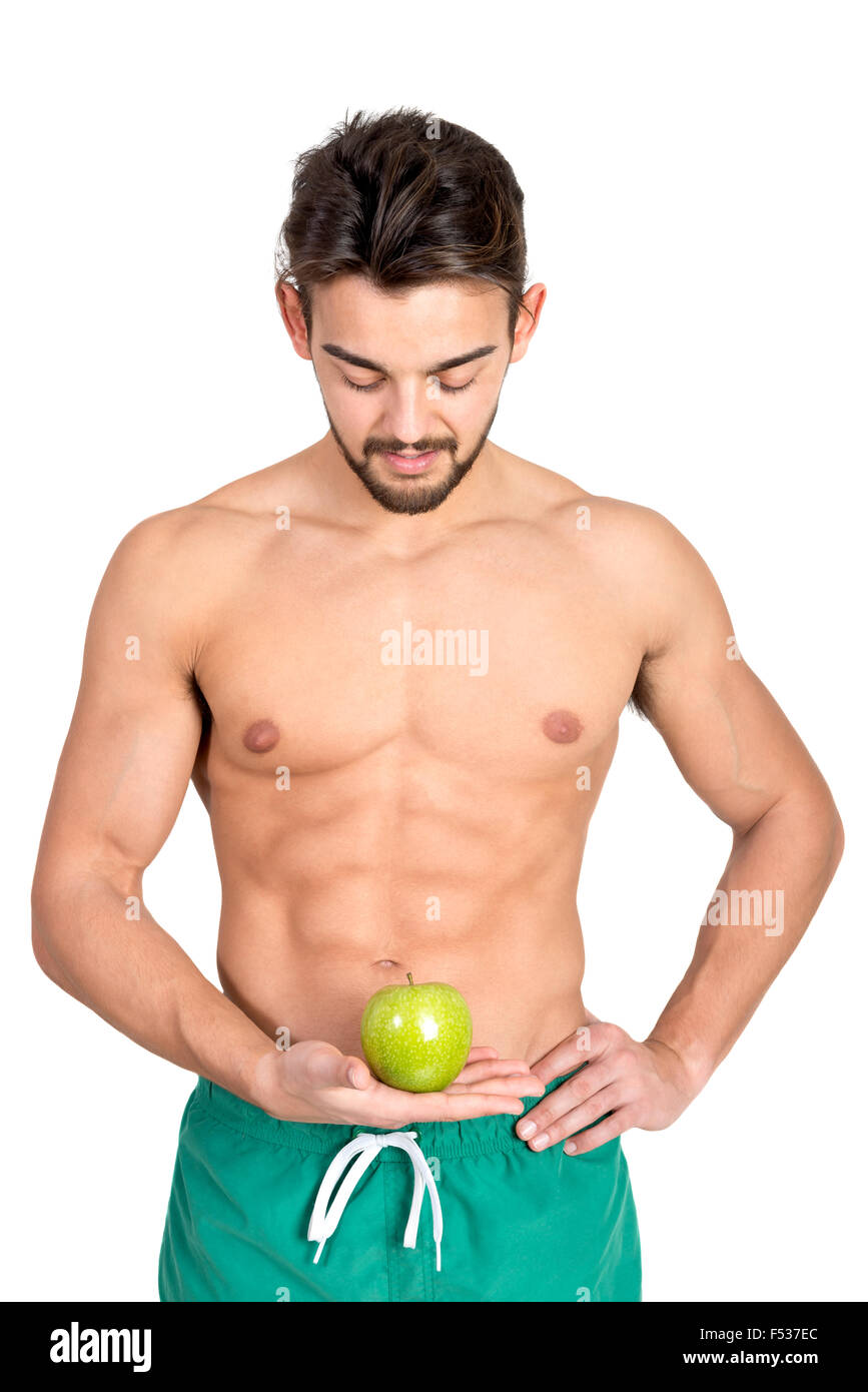 Bello e montare il giovane con un Apple isolato in bianco Foto Stock