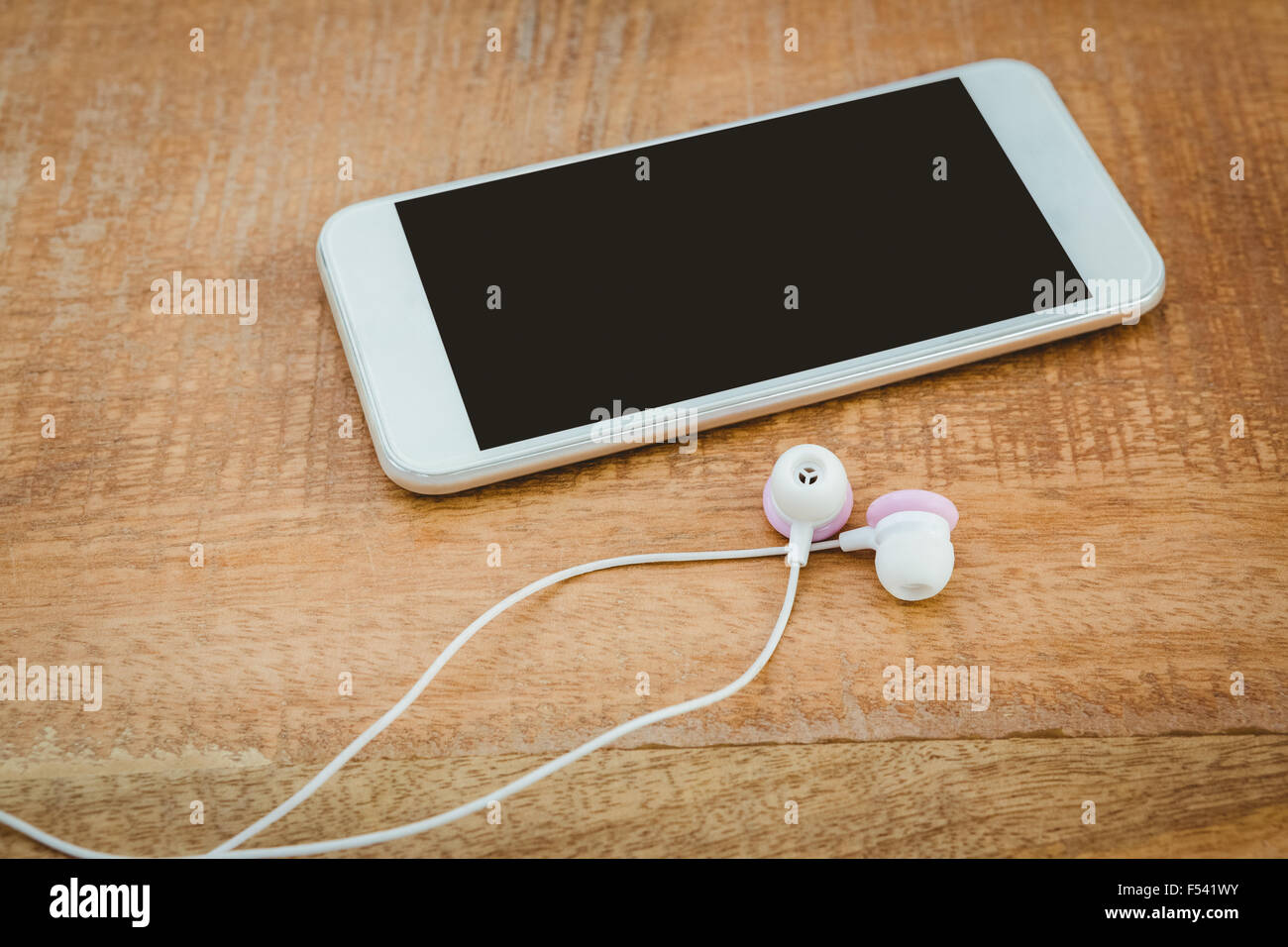 White smartphone con cuffie bianche Foto Stock