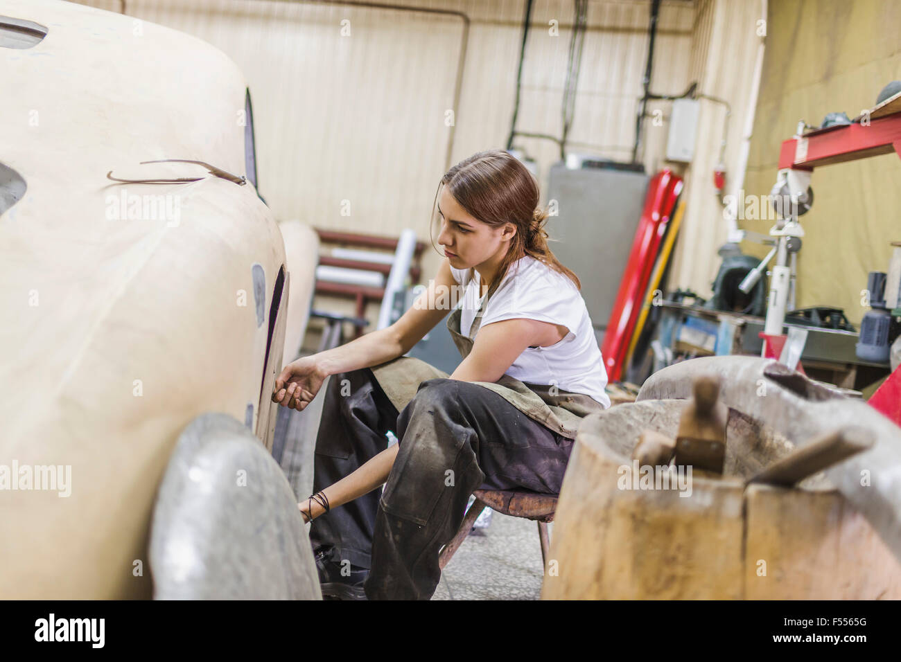 Meccanico femmina riparazione auto al negozio di riparazione Foto Stock
