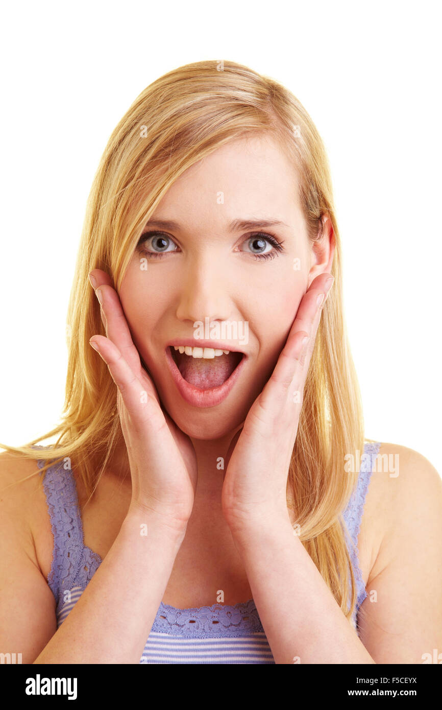 Giovane donna felice guardando sorpreso ed entusiasmato Foto Stock