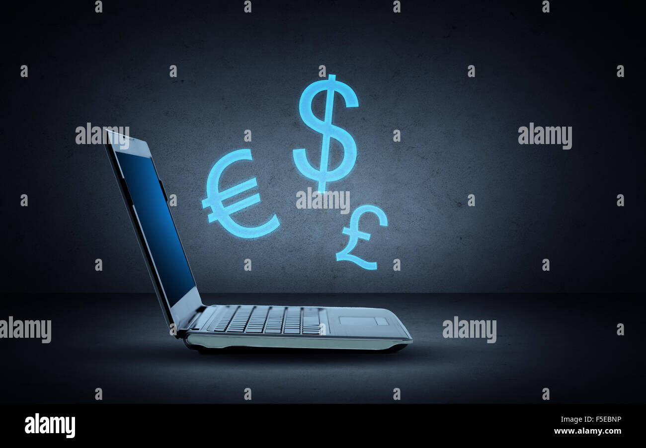 Computer portatile con illuminazione simboli di valuta Foto Stock