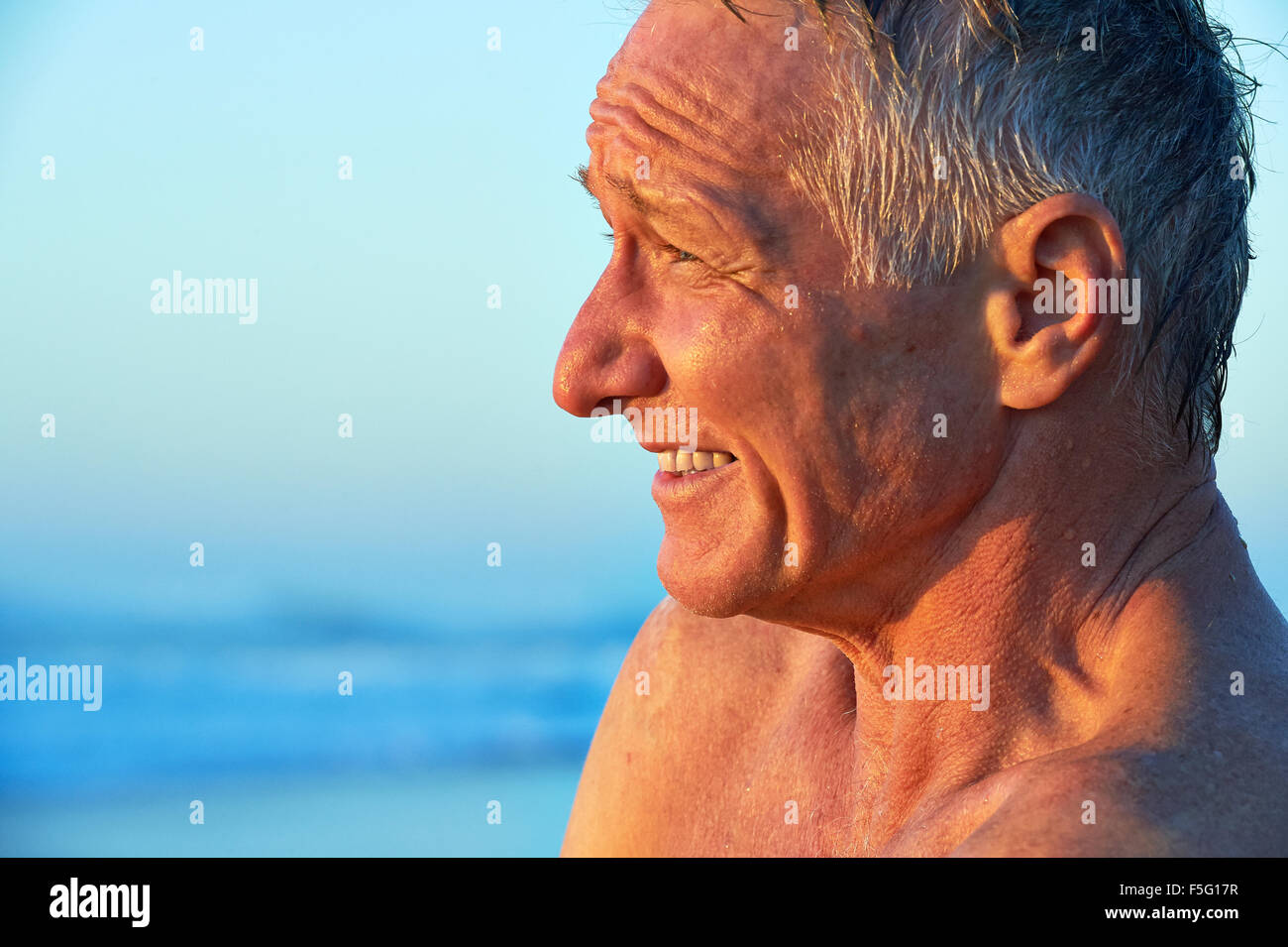 Ritratto di lato di una matura età l uomo sulla spiaggia Foto Stock