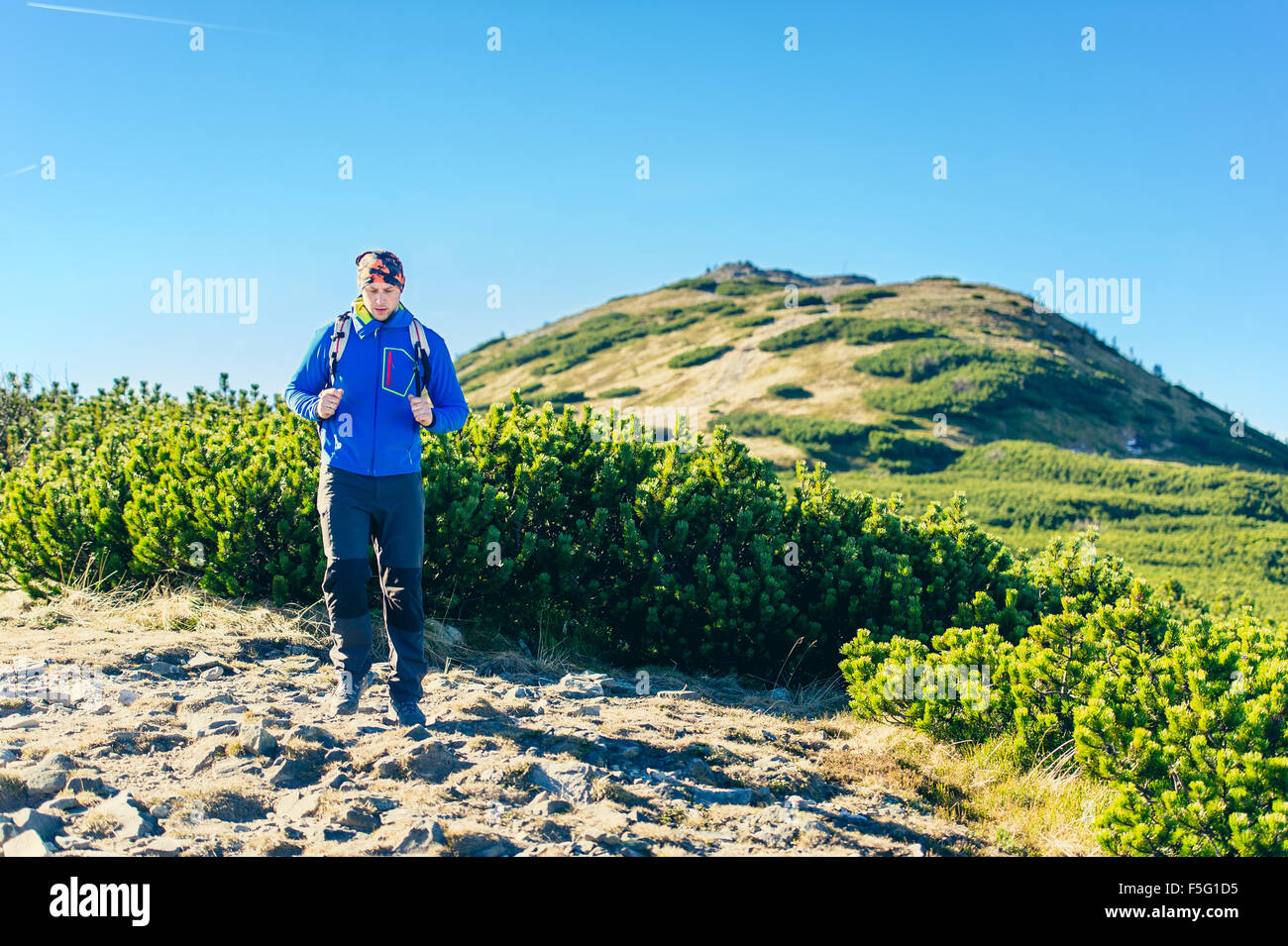 L'uomo escursionista trekking in montagna Foto Stock