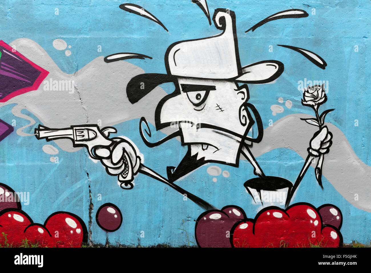 Personaggio dei fumetti con la pistola e rose, graffiti, arte di strada, Duisburg, distretto della Ruhr, Nord Reno-Westfalia, Germania Foto Stock