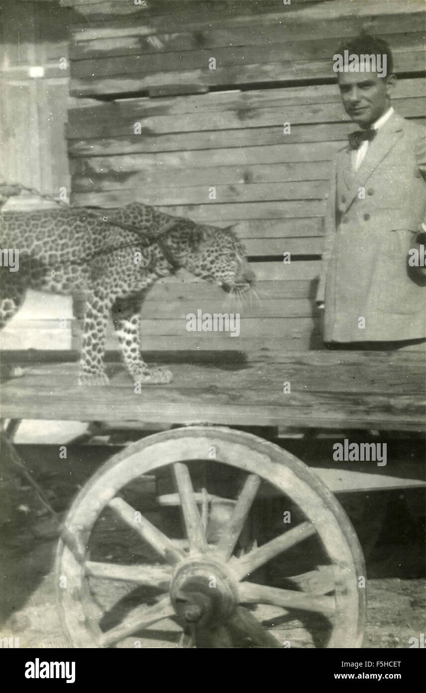 Un uomo accanto a un Leopard su un guinzaglio Foto Stock