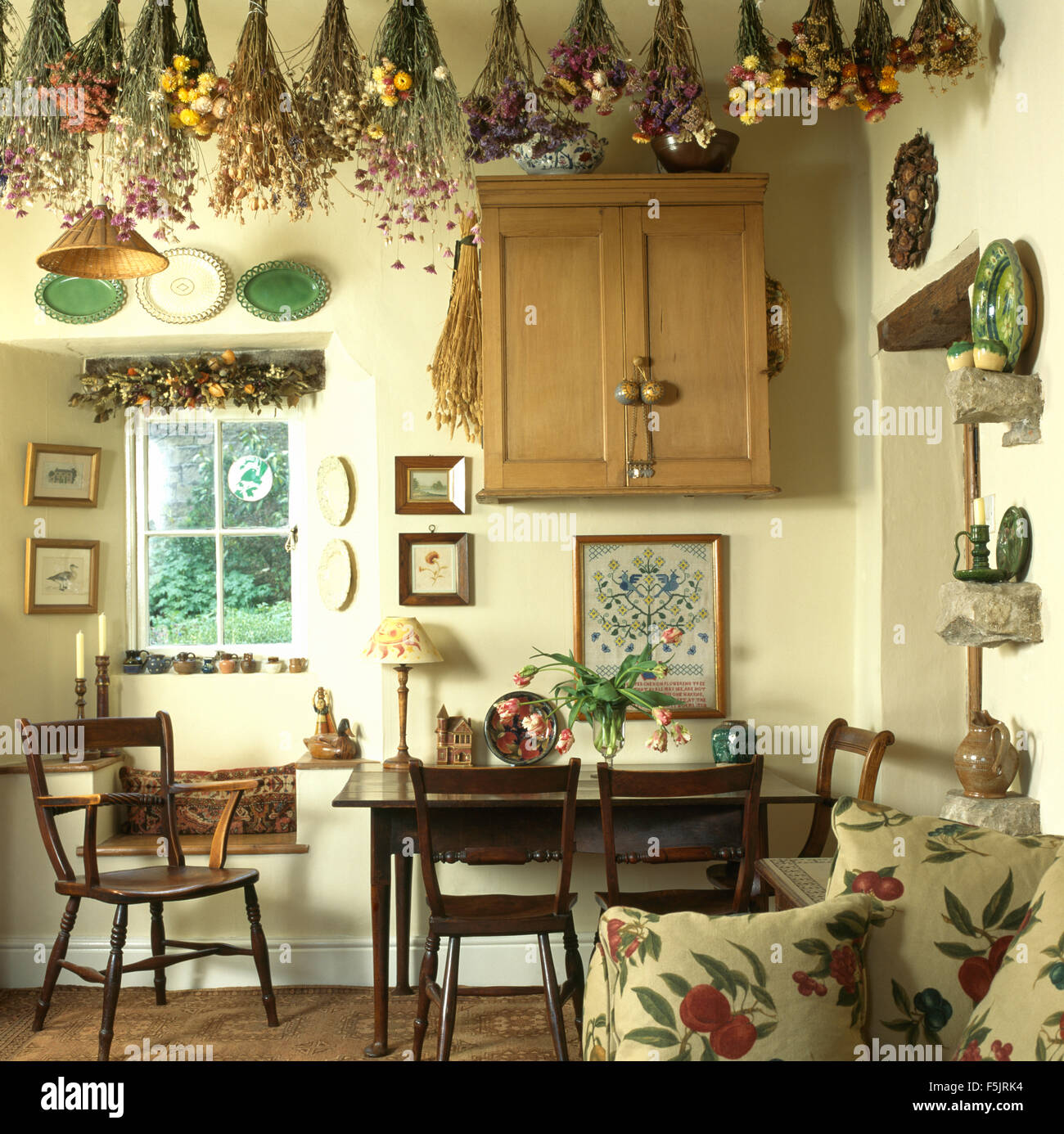 Fiori Secchi pendenti dal soffitto in piccoli cottage sala da pranzo Foto Stock