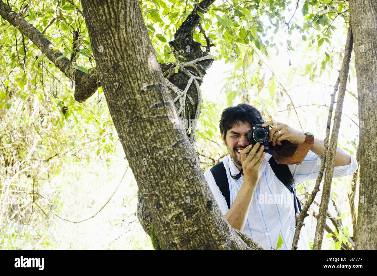 Metà uomo adulto fotografare da albero, Zambia Foto Stock