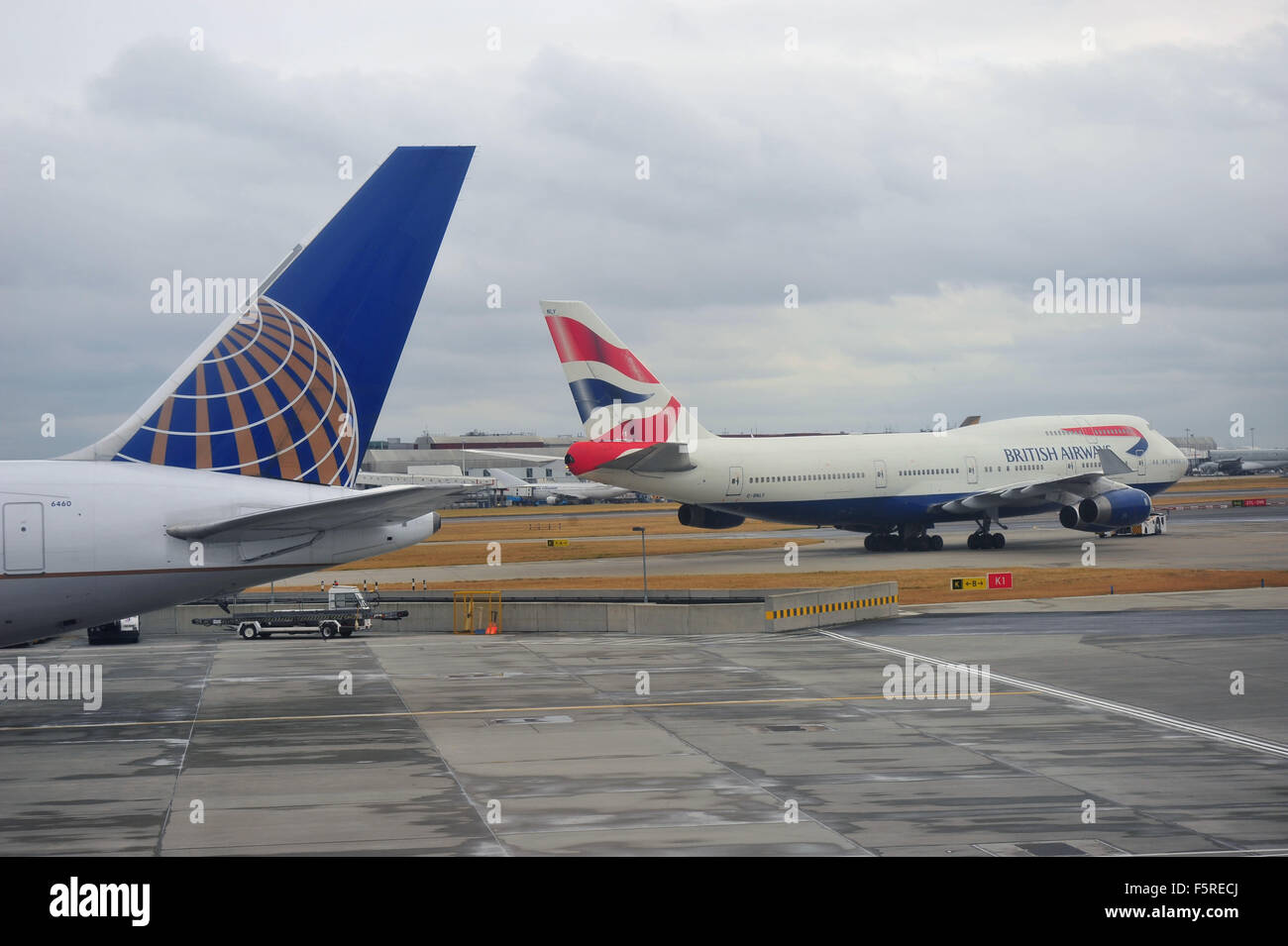 Un British Airways Boeing 747 passa la coda della United Airlines piano sulla terra a Heathrow Airport NEL REGNO UNITO. Foto Stock