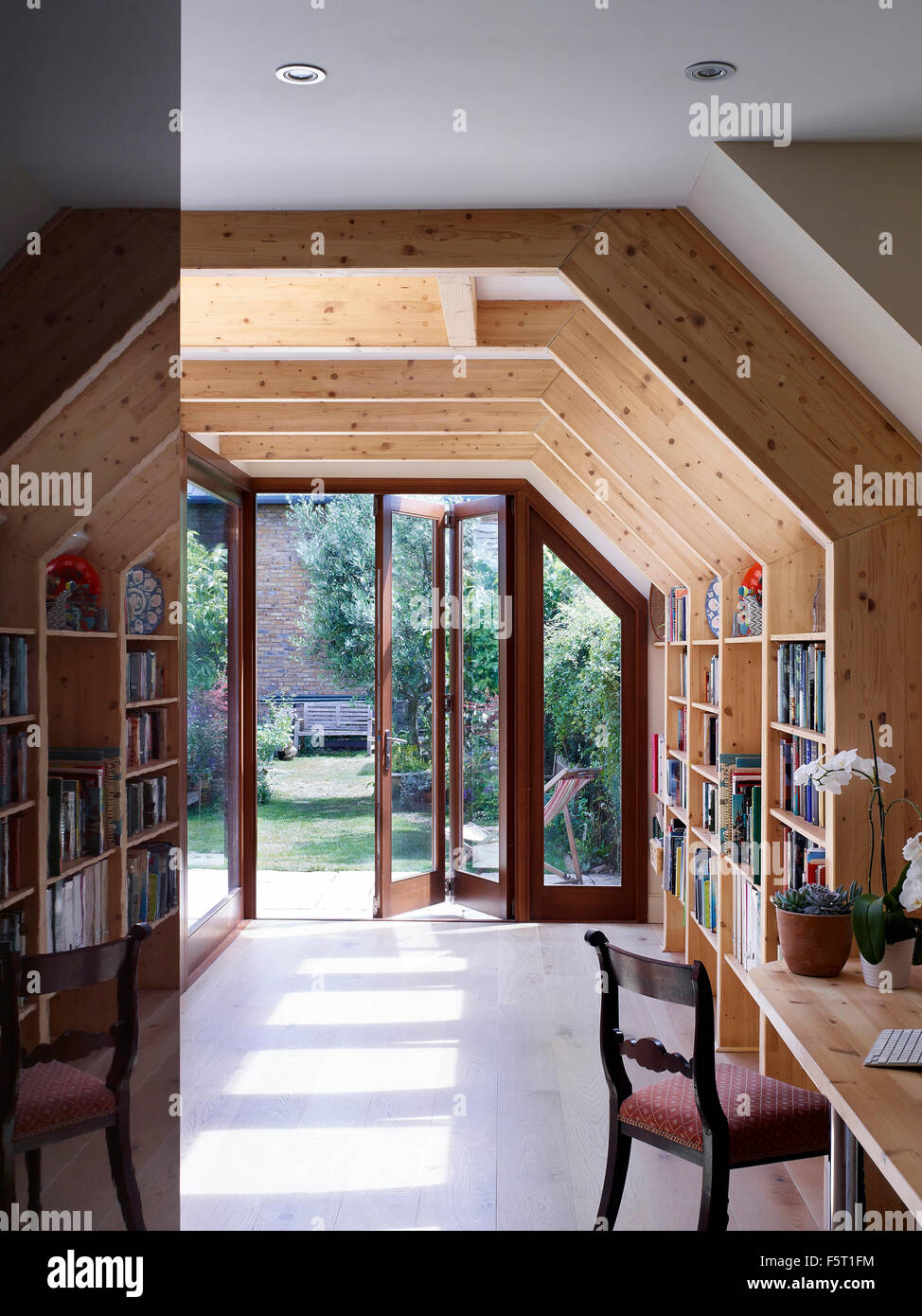 Area di lettura e biblioteca con vista giardino. Wendell Rd, London, Regno Unito. Architetto: Tate Harmer LLP, 2015. Foto Stock