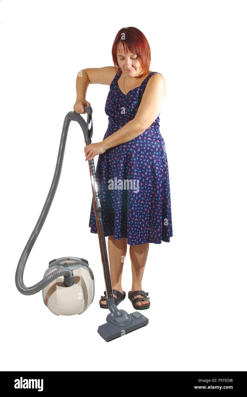 Faccende di Casa - pulizia. Donna con un aspirapolvere su uno sfondo bianco, isolata. Foto Stock