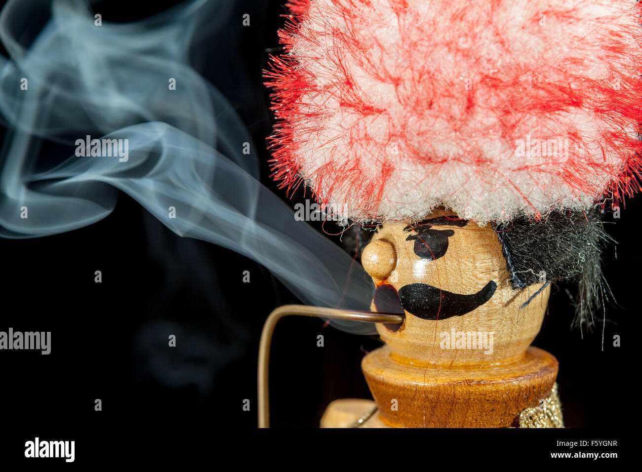 Un fumo uomo di legno con un grande cappello Foto Stock