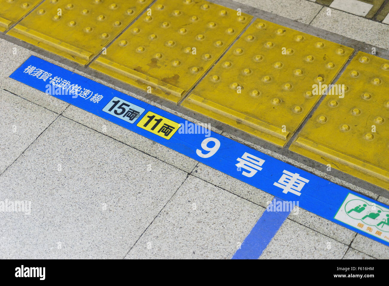 Contrassegni su una piattaforma ferroviaria a Tokyo per mostrare dove riposare. Foto Stock