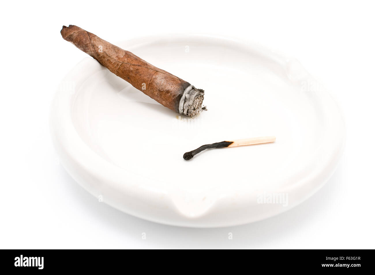 Il fumo di sigaro in un posacenere isolato su bianco Foto Stock