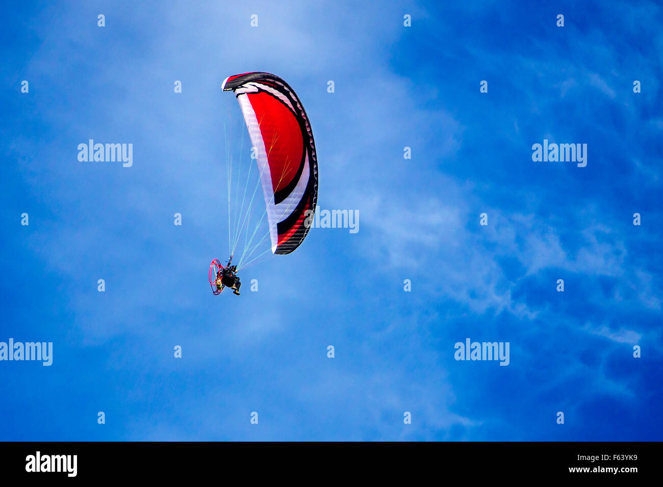 Parapendio con motore vola nel cielo blu Foto Stock