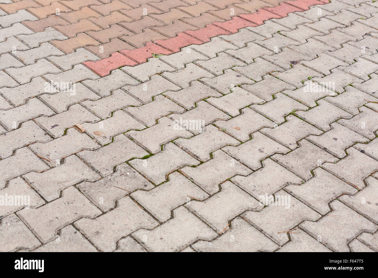 Mattone rosso pietre per pavimentazione su un marciapiede. Foto Stock