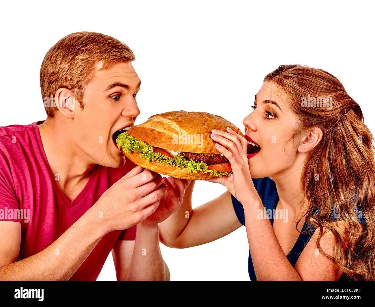 L uomo e la donna a mangiare grandi sandwich. Isolato. Foto Stock