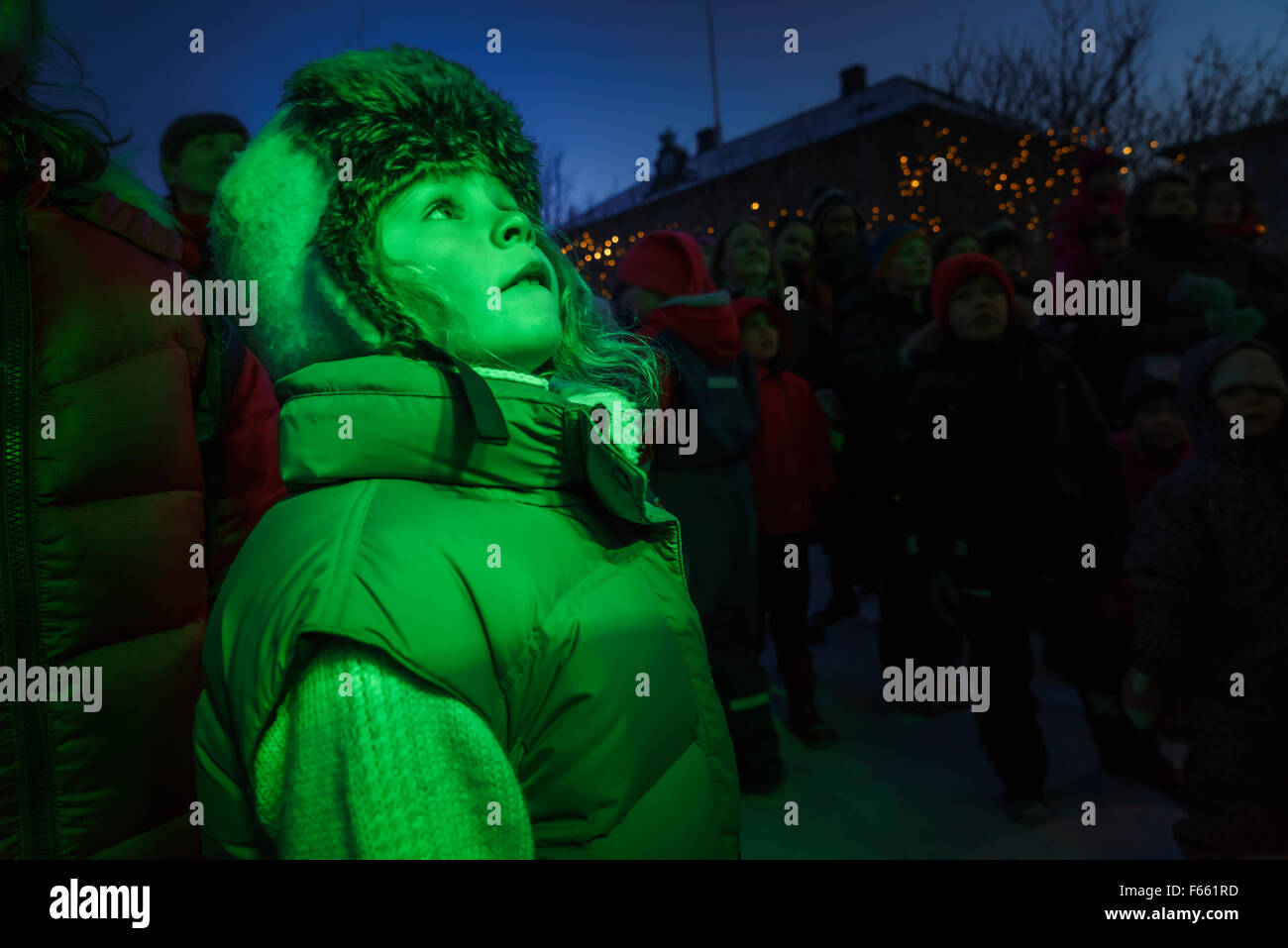 Ragazza giovane guardando i film di Natale all'aperto Reykjavik, Islanda Foto Stock