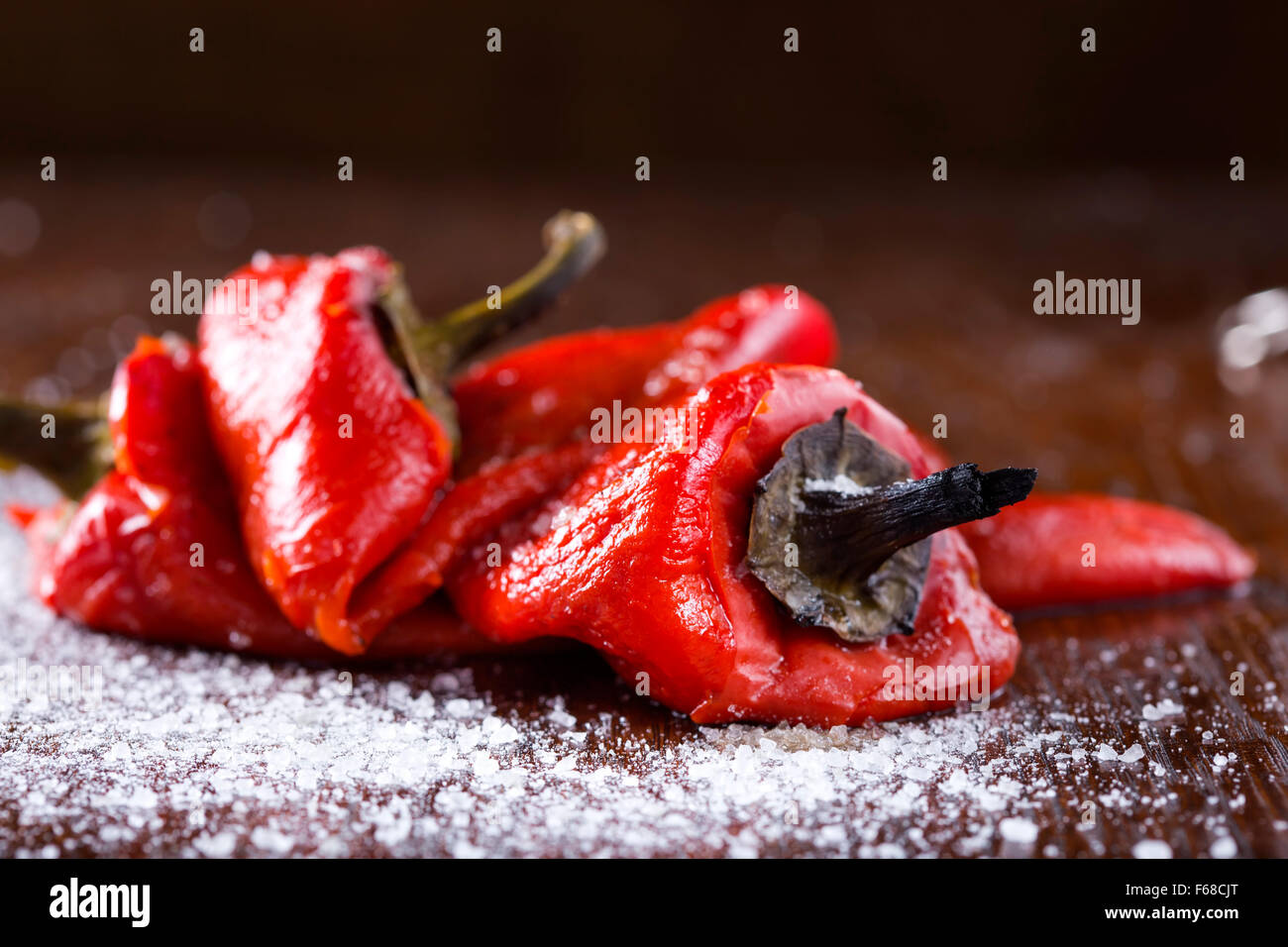 Carni arrosto di pepe rosso con sale su un tavolo di legno Foto Stock
