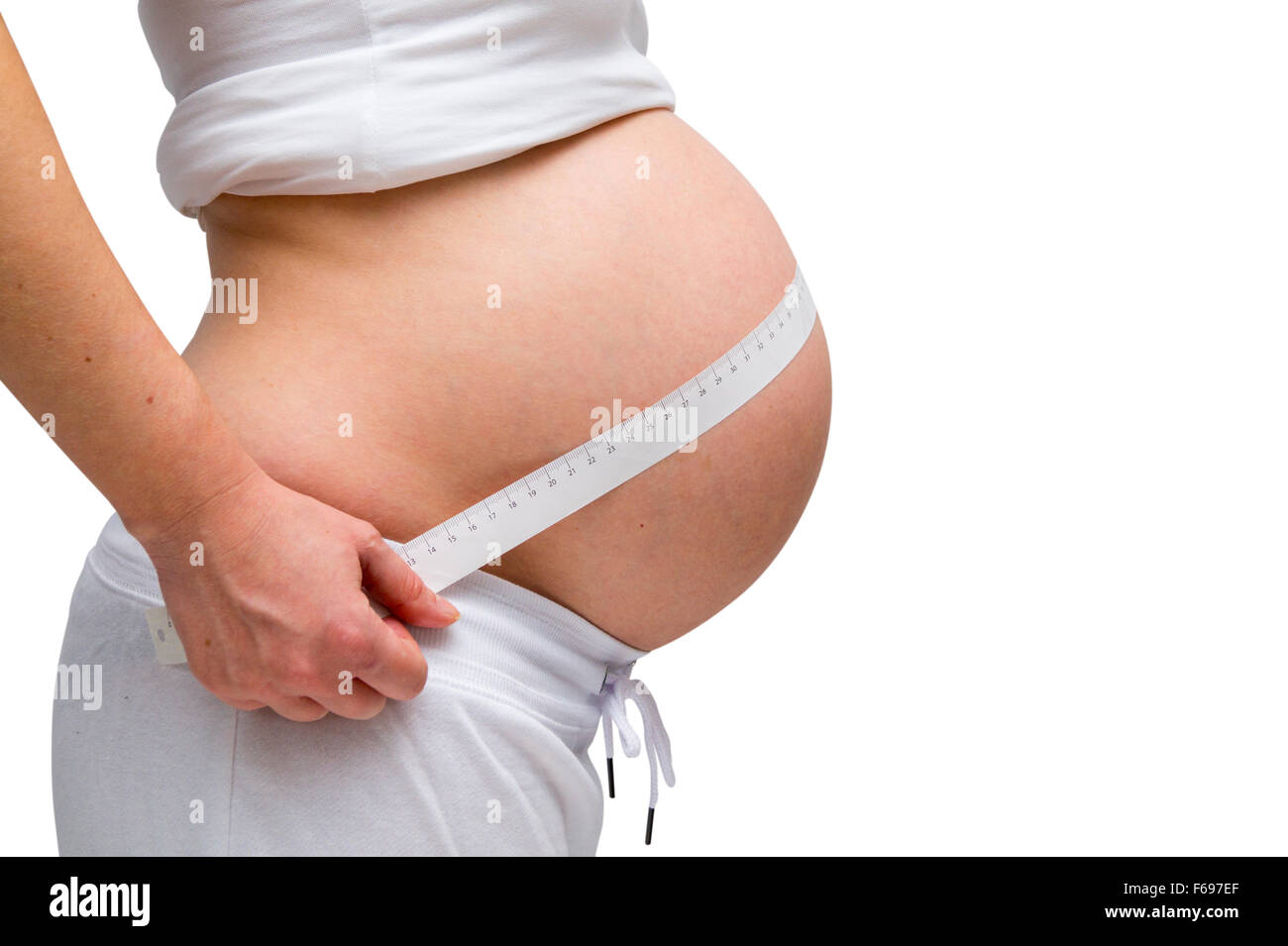 Donne in stato di gravidanza in bianco lounge usura isolato su bianco Foto Stock