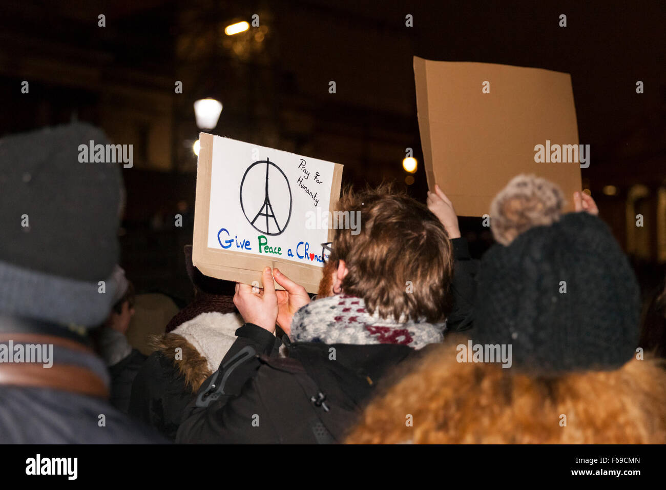 Londra, Regno Unito. Il 14 novembre 2015. Un uomo detiene un 'Date una possibilità alla pace " segno come migliaia di fedeli in Trafalgar Square a pagare il loro rispetto alle vittime in Francia e dimostrare la loro solidarietà a seguito di attacchi di Parigi Foto Stock