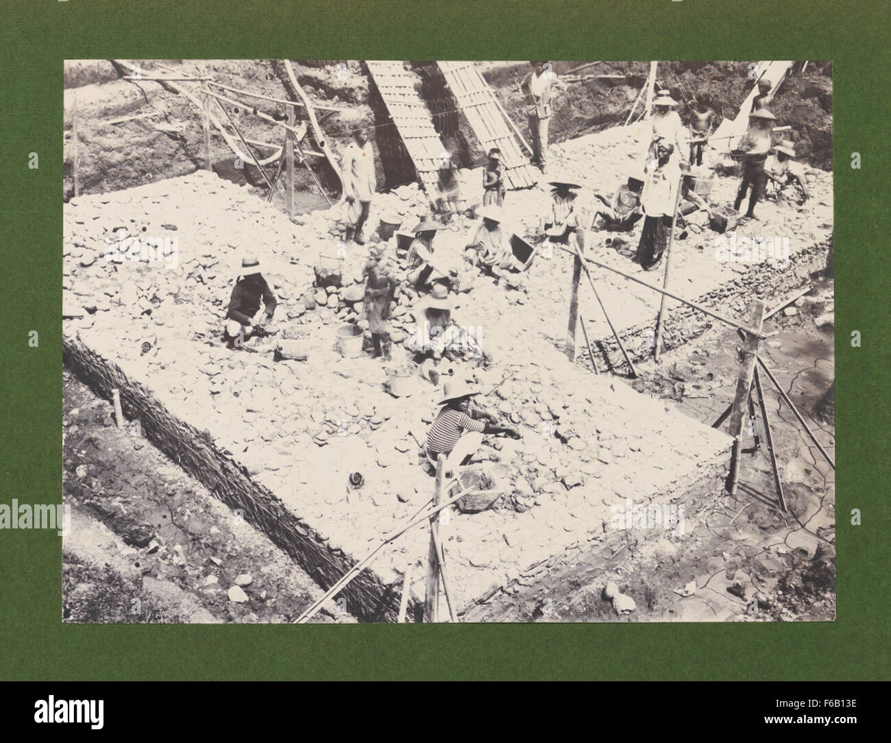 La costruzione del ponte della linea ferroviaria Cirebon-Kroya sul fiume Kali Serayu è un importante progetto di ingegneria in Indonesia. L'immagine raffigura le prime fasi della costruzione del ponte, mostrando i lavoratori e lo sviluppo delle infrastrutture in corso durante il periodo. Foto Stock