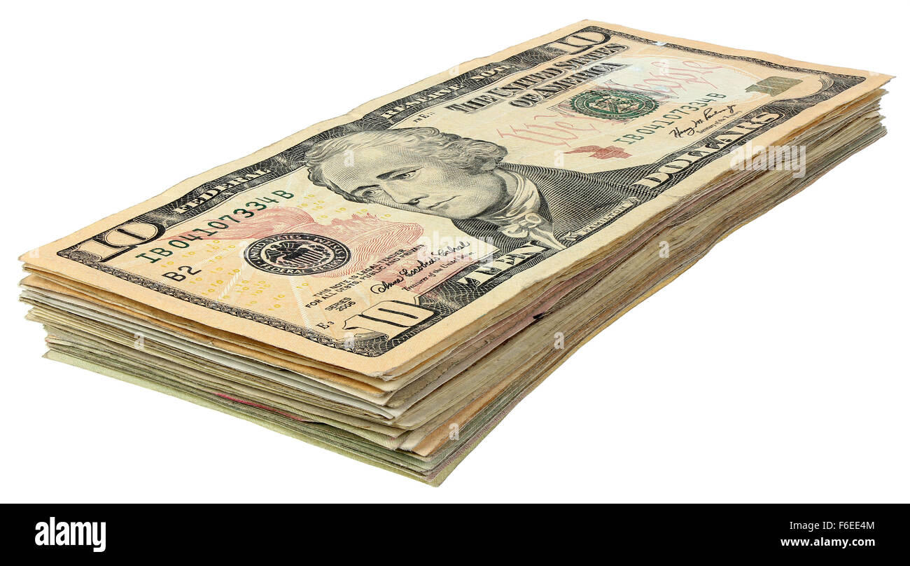 Pila di banconote di dollari isolati su sfondo bianco Foto Stock