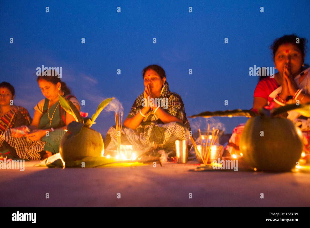 Dacca in Bangladesh. 17 Nov 2015. Migliaia di devoti indù si siede con Prodip e prega Dio di fronte Shri Shri Lokanath Brahmachari Ashram tempio durante il Kartik Brati o Rakher Upobash Dhaka il 17 novembre 2015. Ogni anno migliaia di devoti indù si riuniscono di fronte di Shri Shri Lokenath Brahmachari Ashram tempio per il Kartik Brati o Rakher Upobash festival religioso in Barodi, vicino a Dacca in Bangladesh. Fedeli di sedersi di fronte luce delle candele ( chiamato localmente come Prodip ) e assorbire nella preghiera...Lokenath Brahmachari chi è chiamato Baba Lokenath era un 18t Foto Stock