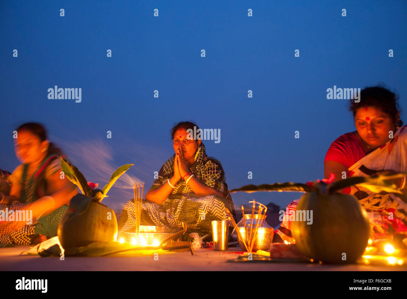 Dacca in Bangladesh. 17 Nov 2015. Migliaia di devoti indù si siede con Prodip e prega Dio di fronte Shri Shri Lokanath Brahmachari Ashram tempio durante il Kartik Brati o Rakher Upobash Dhaka il 17 novembre 2015. Ogni anno migliaia di devoti indù si riuniscono di fronte di Shri Shri Lokenath Brahmachari Ashram tempio per il Kartik Brati o Rakher Upobash festival religioso in Barodi, vicino a Dacca in Bangladesh. Fedeli di sedersi di fronte luce delle candele ( chiamato localmente come Prodip ) e assorbire nella preghiera...Lokenath Brahmachari chi è chiamato Baba Lokenath era un 18t Foto Stock