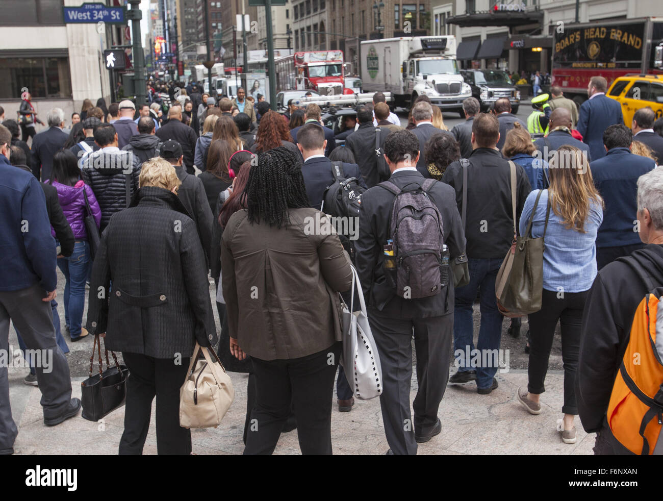 Mattina Rush Hour folle di edificio per uffici lavoratori cross 34th Street e la 7th Avenue in Manhattan. Foto Stock