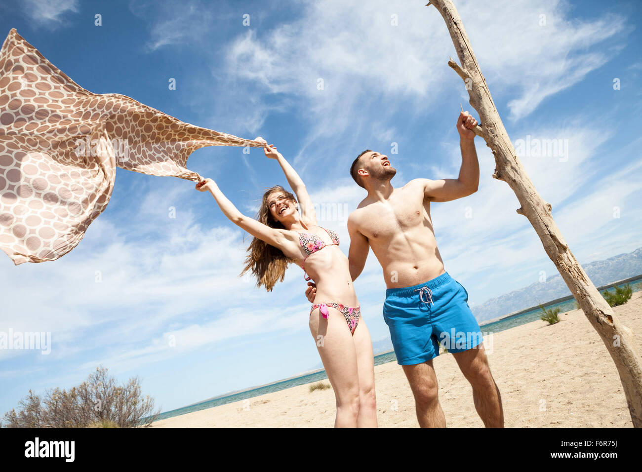 Felice coppia giovane sulla spiaggia ingannare circa Foto Stock