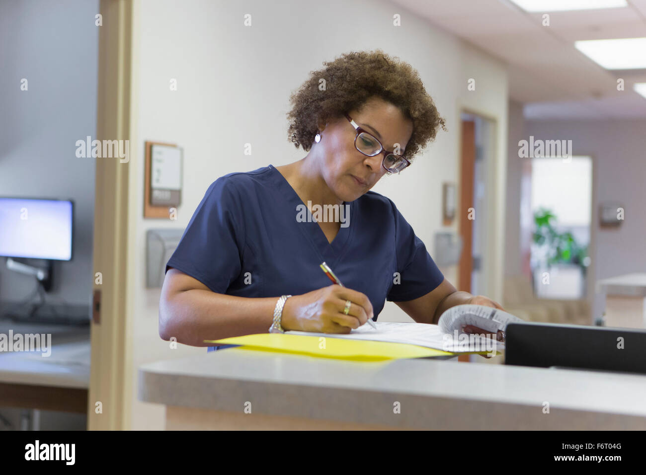 African American infermiere iscritto in ospedale Foto Stock