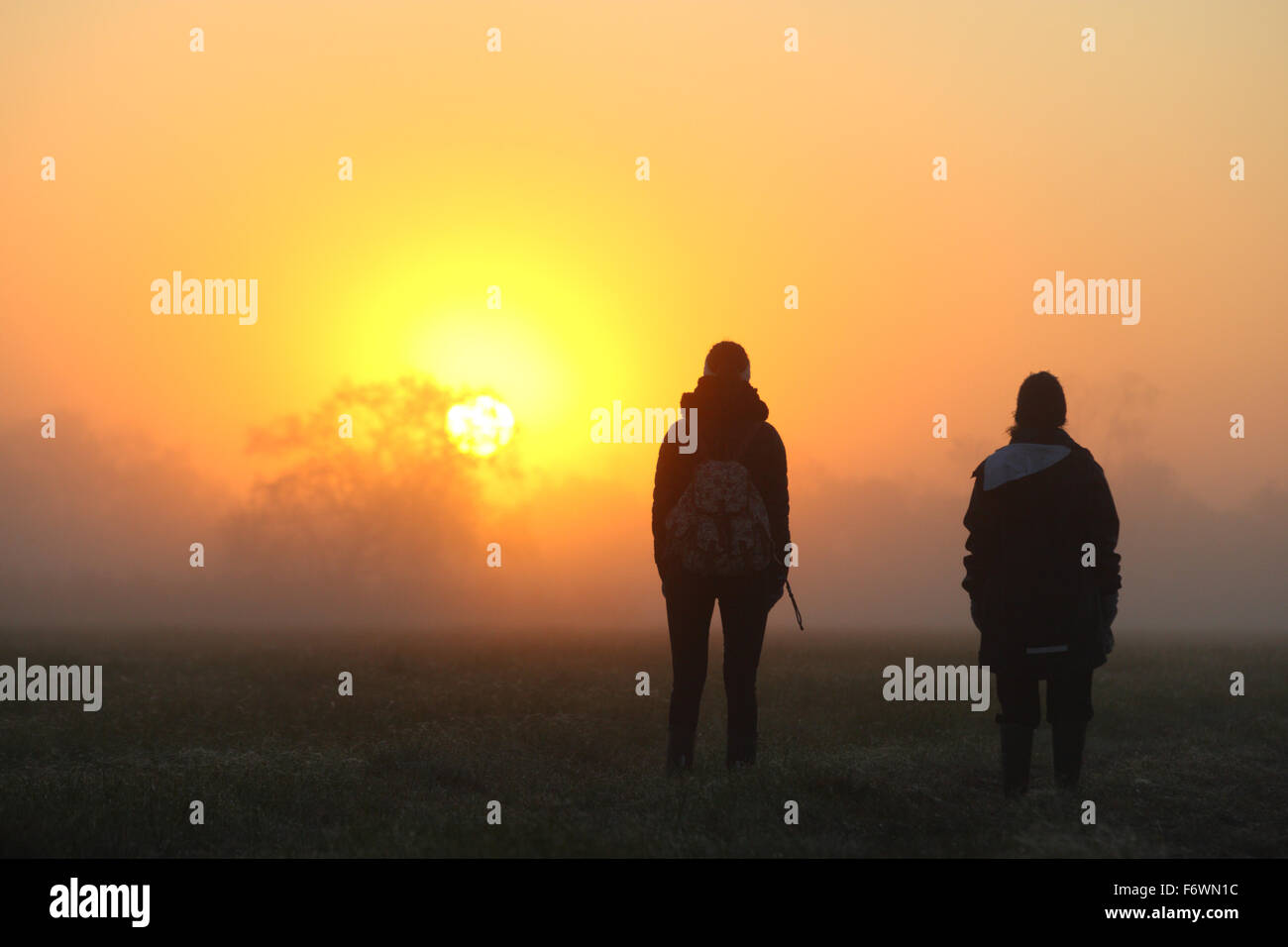 Girls Watching il sunrise presso la cassa di espansione Foto Stock