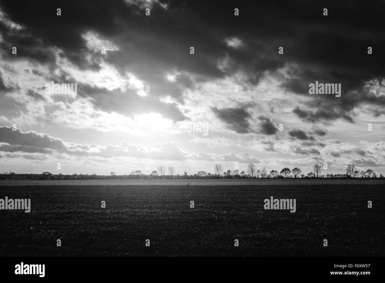 Canary Wharf Cityscape il paesaggio può essere visto nel lontano contro un tramonto di un cielo nuvoloso Foto Stock