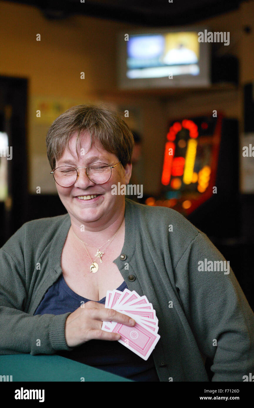 La donna la riproduzione di un gioco di carte in un pub, Foto Stock