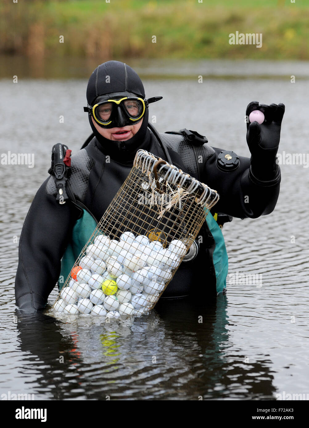 Palla da golf subacqueo Ralf Oestmann detiene il self-made cesti riempiti  con palline da golf nelle sue mani su un campo da golf a Bremen, Germania,  10 novembre 2015. Oestmann pesci per