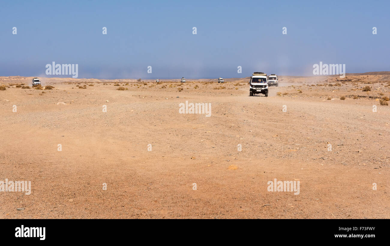 Egitto, nero deserto. Spostamento veicolo fuoristrada con una vista panoramica sul deserto di pietra . Le tracce sulla sabbia del settore automotive Foto Stock