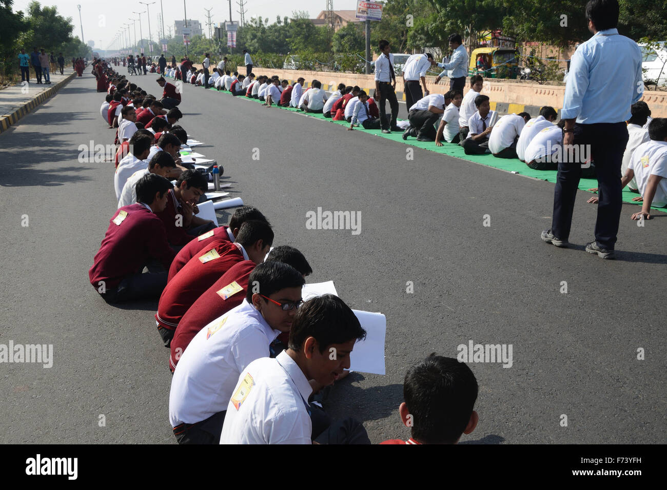 I ragazzi della scuola seduti sulla strada per il concorso di disegno, Jodhpur, Rajasthan, India Foto Stock